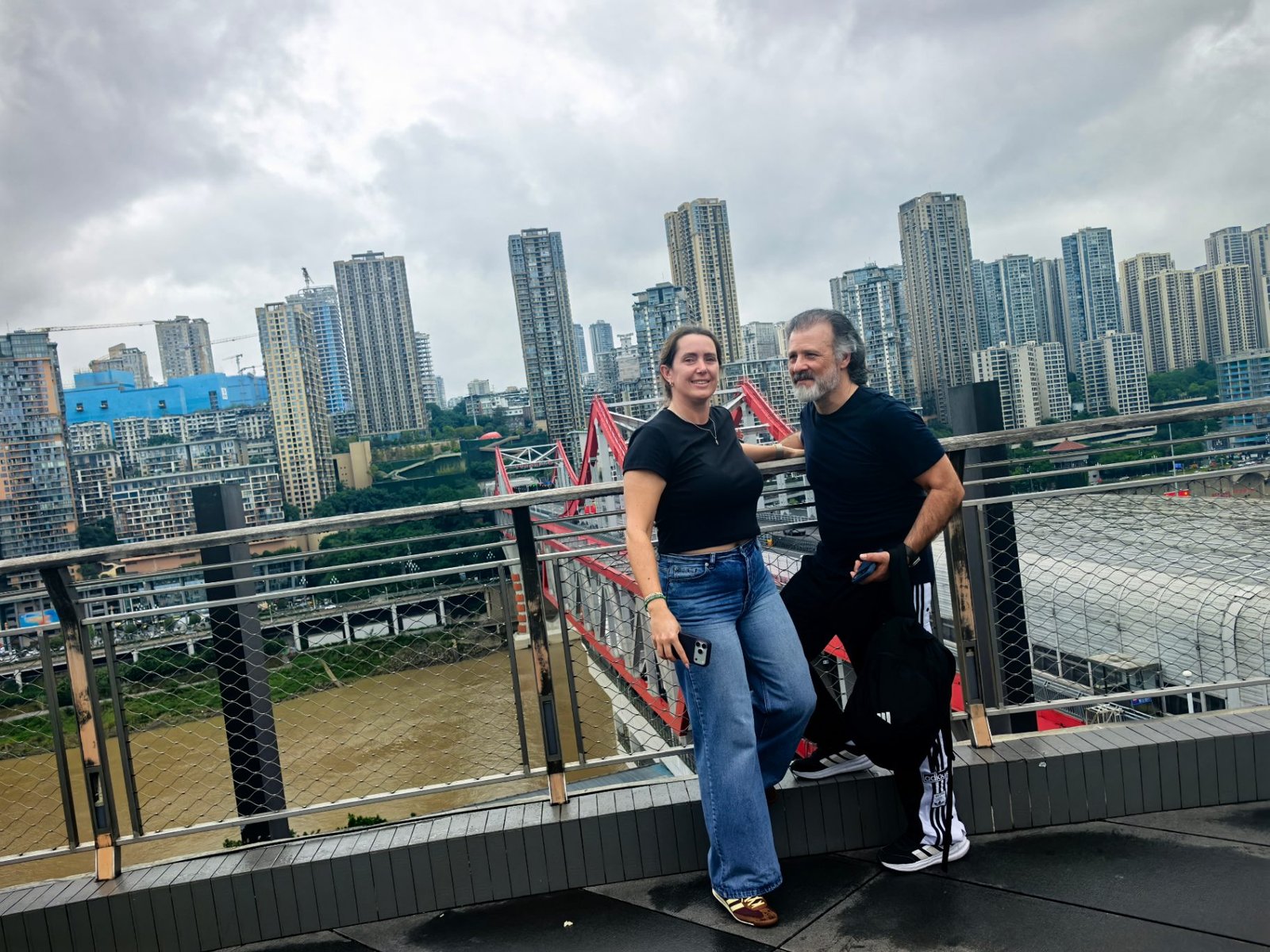 Couple from Spain on their tailor-made China itinerary overlooking the river bridges of Chongqing