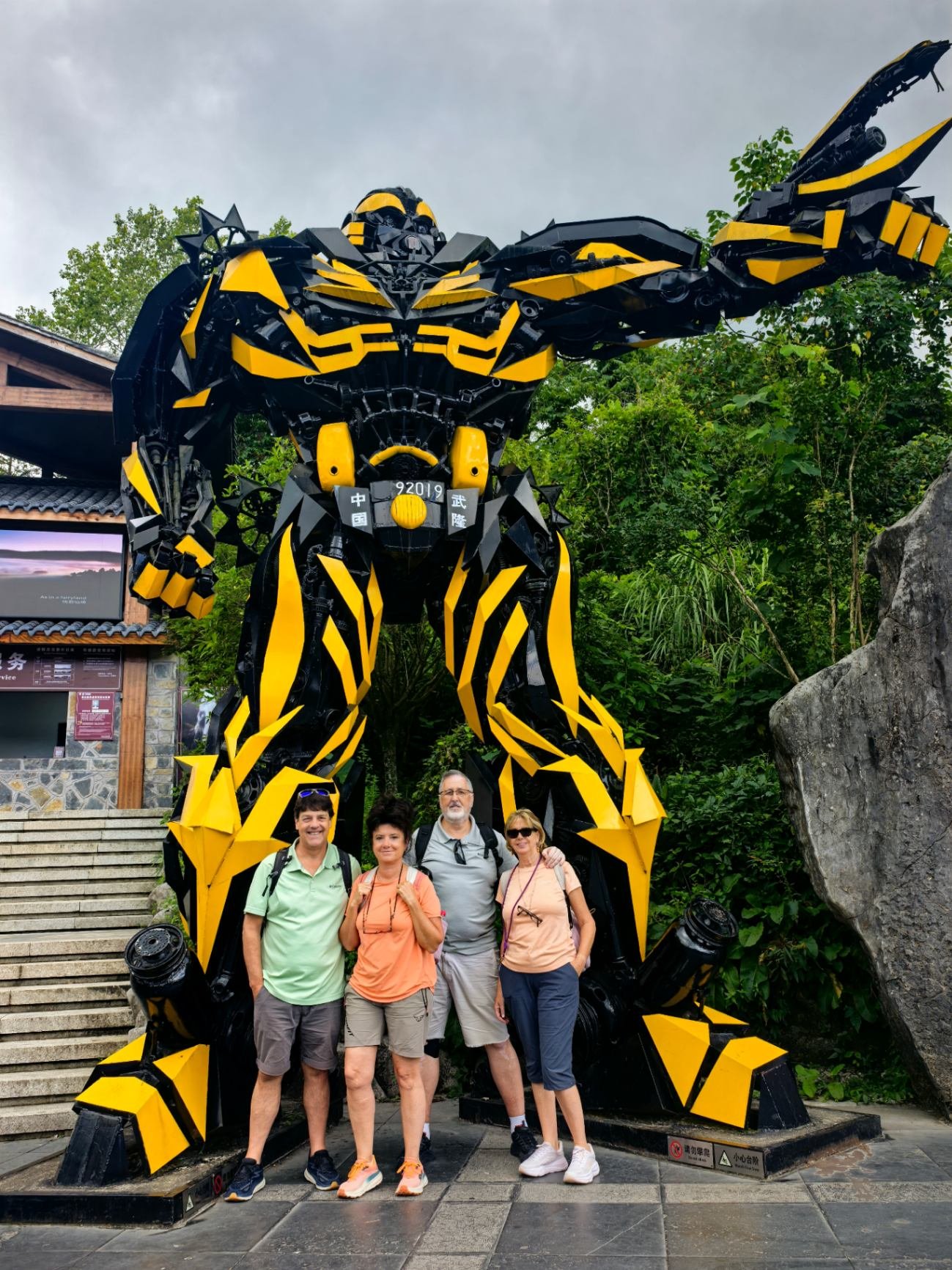 Guests posing with the giant Transformers sculpture at Wulong during their private China tour